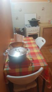 a kitchen with a table with a pot on it at La Guadeloupéenne in Saint-Joseph