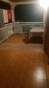 a room with a bench sitting on a tiled floor at La Guadeloupéenne in Saint-Joseph