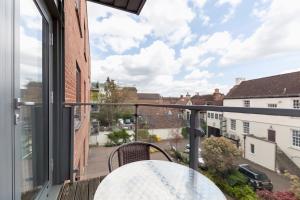 a balcony with a table and a view of a street at Roomspace Serviced Apartments - Marquis Court in Epsom