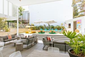 a patio with couches and chairs and a playground at Cottesloe Beach Hotel in Perth