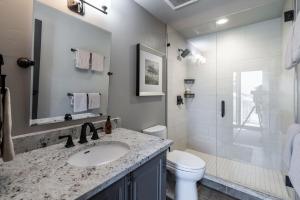 a bathroom with a sink and a toilet and a shower at Penthouse Condo In The Heart Of The Ski Area! in Steamboat Springs +23 photos