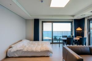 a bedroom with a bed and a table with chairs at More than Sokcho in Sokcho +93 photos