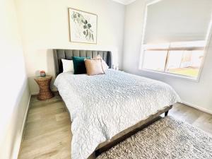 a bedroom with a large bed and a window at Clarys House - Nestled in the heart of Tanunda in Tanunda +13 photos