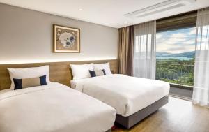 Postel nebo postele na pokoji v ubytování Kensington Resort Gyeongju