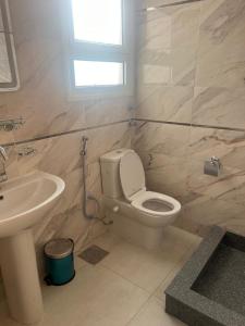 a bathroom with a toilet and a sink at Star house apartments in Hurghada +11 photos