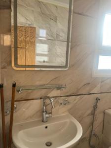 a bathroom with a sink and a mirror at Star house apartments in Hurghada