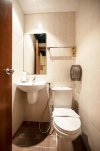 a bathroom with a toilet and a sink at Fragrance Hotel - Rose in Singapore +13 photos