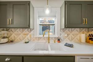 a kitchen with a sink and a window at Walk To Cherry Street,pets, Hot Tub By Hvnlyhomes in Tulsa +57 photos