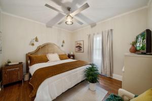 a bedroom with a bed with a ceiling fan at Walk To Cherry Street,pets, Hot Tub By Hvnlyhomes in Tulsa