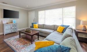 a living room with a couch and a table at Game Room, Pool & Fire Pit At The Medical Center in San Antonio +80 photos