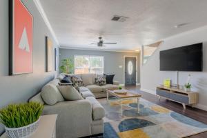 a living room with a couch and a tv at Gameroom, Bbq & Hot-tub By Lackland & Seaworld in San Antonio