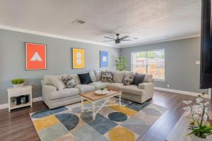 a living room with a couch and a table at Gameroom, Bbq & Hot-tub By Lackland & Seaworld in San Antonio