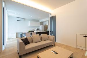 a living room with a couch and a table at Mova Villa Koshi Misawa south in Kikutomi