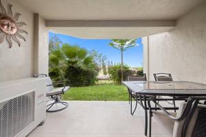 a patio with a table and a table and chairs at 6 Bed 4 Bath Condo in Waikoloa Village in Waikoloa Village