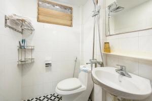 a white bathroom with a toilet and a sink at The La Renta Hotel & Spa in Hanoi +32 photos