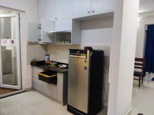 a kitchen with a black and silver refrigerator in it at Modern 3BHK with Well-Equipped kitchen on 22 flr, Parking & Club House Perfect for Families in Bengaluru