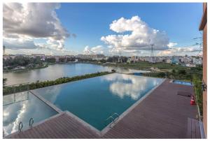 a large swimming pool with a view of a river at Modern 3BHK with Well-Equipped kitchen on 22 flr, Parking & Club House Perfect for Families in Bengaluru