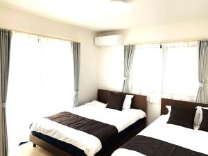 Postel nebo postele na pokoji v ubytování Daiichi House