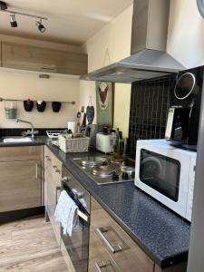 a kitchen with a microwave and a stove top oven at The coach house in Grimston