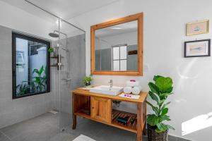 a bathroom with a sink and a mirror at Villa Nautica By The Beach - Vesta Collections in Hoi An +54 photos