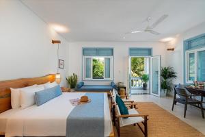 a bedroom with a bed and a dining room at Villa Nautica By The Beach - Vesta Collections in Hoi An