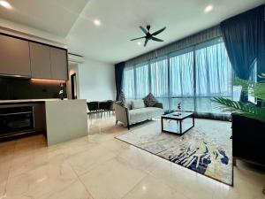 a living room with a couch and a ceiling fan at Opus Residence KL by EUcation Hospitality in Kuala Lumpur