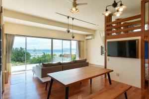 a living room with a couch and a table at オーシャンヴィラ 海テラス Ishigaki in Ishigaki Island