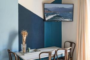 a dining room with a table and a tv on the wall at LevOasi 9 - Lake and mountains escape in Levo