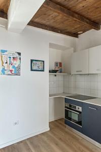 a kitchen with white walls and a wooden ceiling at LevOasi 9 - Lake and mountains escape in Levo +28 photos