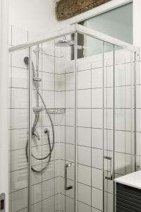 a shower with a glass door in a bathroom at LevOasi 7 - Garden, jacuzzi and sauna escape in Levo +29 photos
