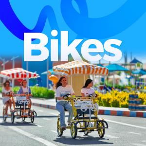 a group of women riding bikes down a street at Pickalbatros Jungle Aqua Park - Neverland Hurghada in Hurghada