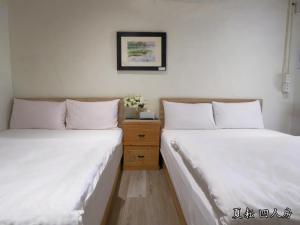 Postel nebo postele na pokoji v ubytování 玉蟾園民宿 寵物友善 YuChanYuan B&B