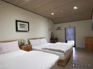 Postel nebo postele na pokoji v ubytování 玉蟾園民宿 寵物友善 YuChanYuan B&B