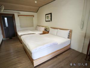 Postel nebo postele na pokoji v ubytování 玉蟾園民宿 寵物友善 YuChanYuan B&B