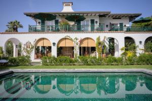 a house with a swimming pool in front of it at California Park Hotel in Forte dei Marmi