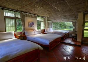 Postel nebo postele na pokoji v ubytování 玉蟾園民宿 寵物友善 YuChanYuan B&B