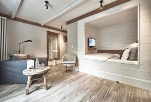 a bedroom with a bed and a table and a chair at The Cozy Hotel & Lofts Timmendorfer Strand in Timmendorfer Strand