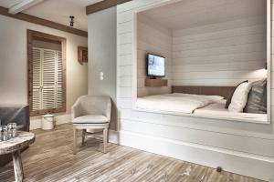 a room with a bed in a wall with a window at The Cozy Hotel & Lofts Timmendorfer Strand in Timmendorfer Strand