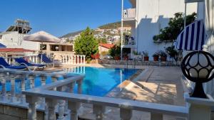 a villa with a swimming pool and a balcony at Kalkan Centre Bijou Home - Walk to town and beach in Kalkan