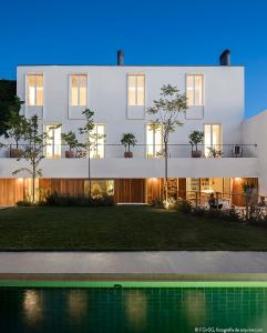 a white building with a pool in front of it at The Late Birds Lisbon - Gay Urban Resort in Lisbon