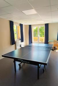 a ping pong table in the middle of a room at Chalet Annapurna in Les Deux Alpes