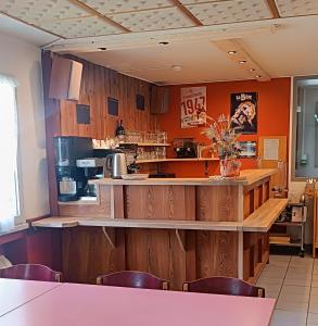 a bar in a restaurant with wooden walls and chairs at Chalet Annapurna in Les Deux Alpes