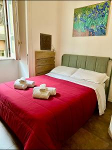 two towels on a bed with a red blanket at B&B A Durmì in Naples