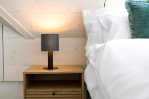 A bed or beds in a room at STAYY Flagship Limmattal - contactless check-in