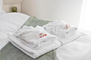 A bed or beds in a room at STAYY Flagship Limmattal - contactless check-in