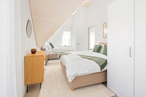 A bed or beds in a room at STAYY Flagship Limmattal - contactless check-in