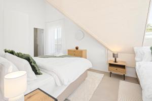 A bed or beds in a room at STAYY Flagship Limmattal - contactless check-in