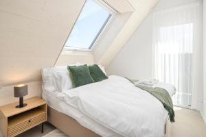 A bed or beds in a room at STAYY Flagship Limmattal - contactless check-in