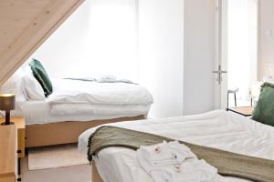 A bed or beds in a room at STAYY Flagship Limmattal - contactless check-in