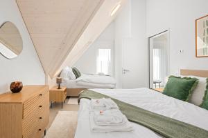 A bed or beds in a room at STAYY Flagship Limmattal - contactless check-in